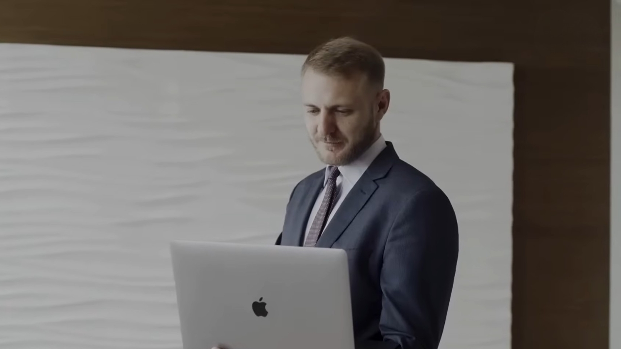 Travel agent uses a laptop in a professional office